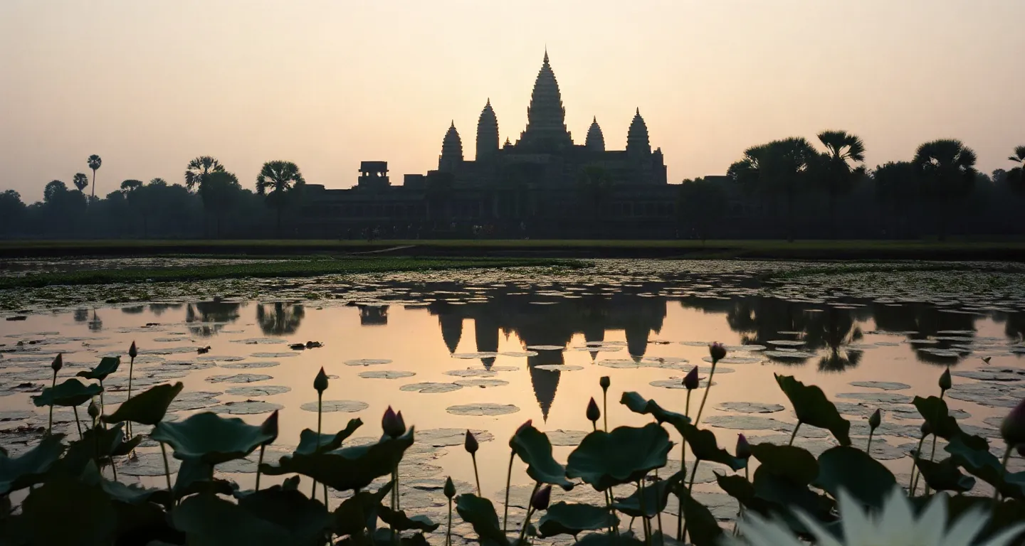 Angkor Wat temple towers reflected in a lotus pond at sunrise, Cambodia