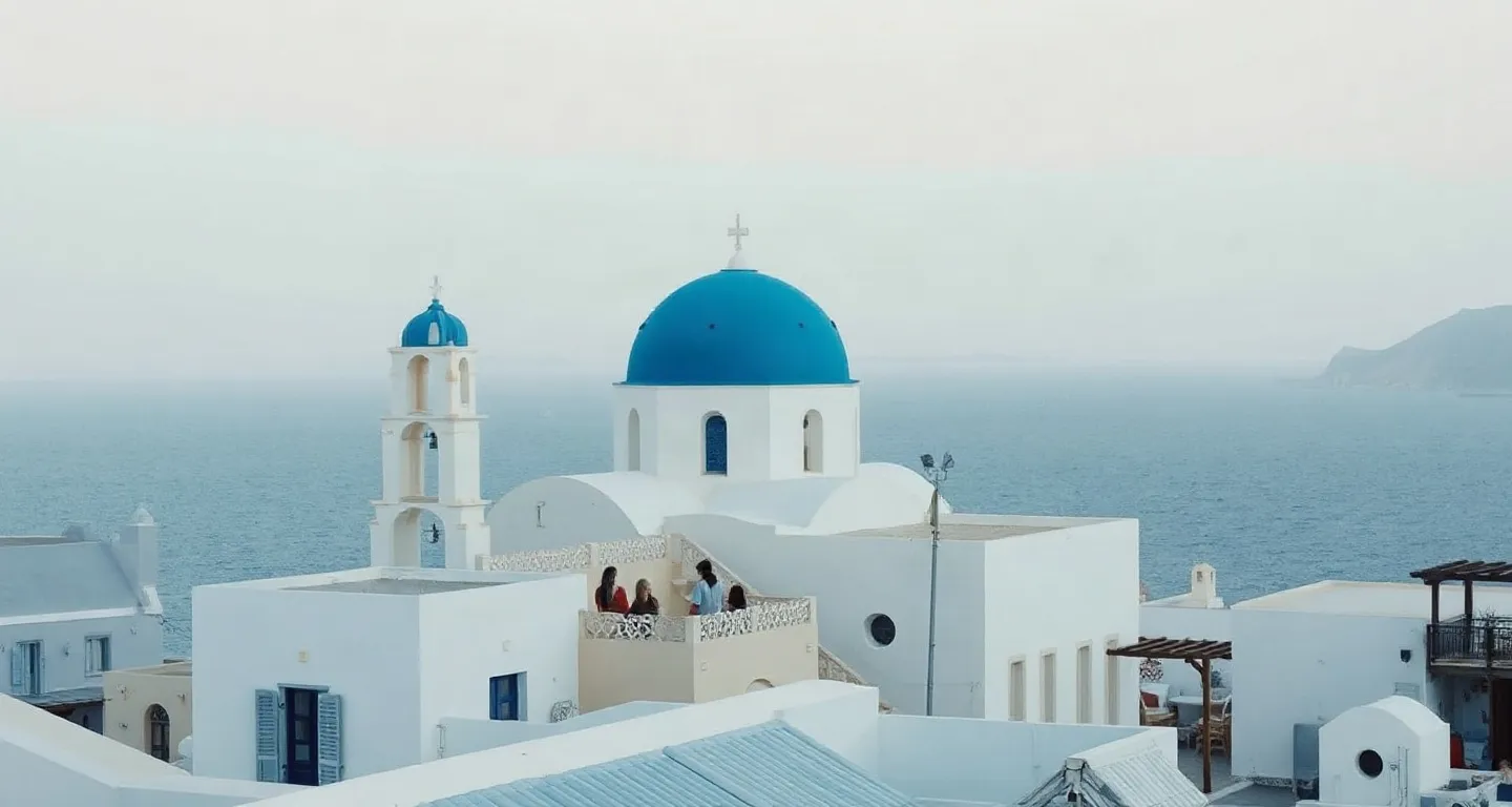 Whitewashed houses and a blue dome above the Aegean Sea on a Greek island