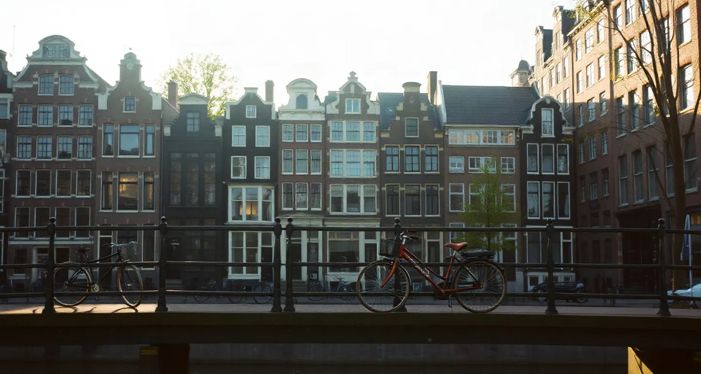 Canal houses and bicycles on a bridge in Amsterdam, Netherlands